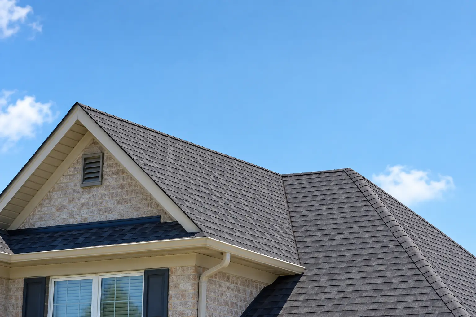 Residential shingle roof in Texas under a clear blue sky